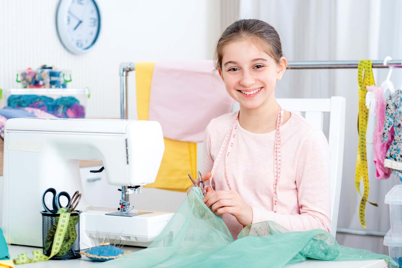 Smiling Little Girl Working At The Sewing Machine