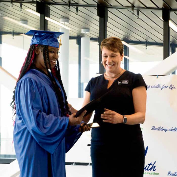 52 Fb2024 08 045 Executive Director, Jen Yonan, Hands Out A Diploma To A Graduating Member