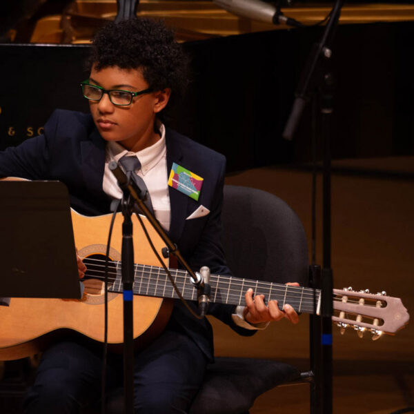 121 Main Reach Teach Play Student Playing The Guitar