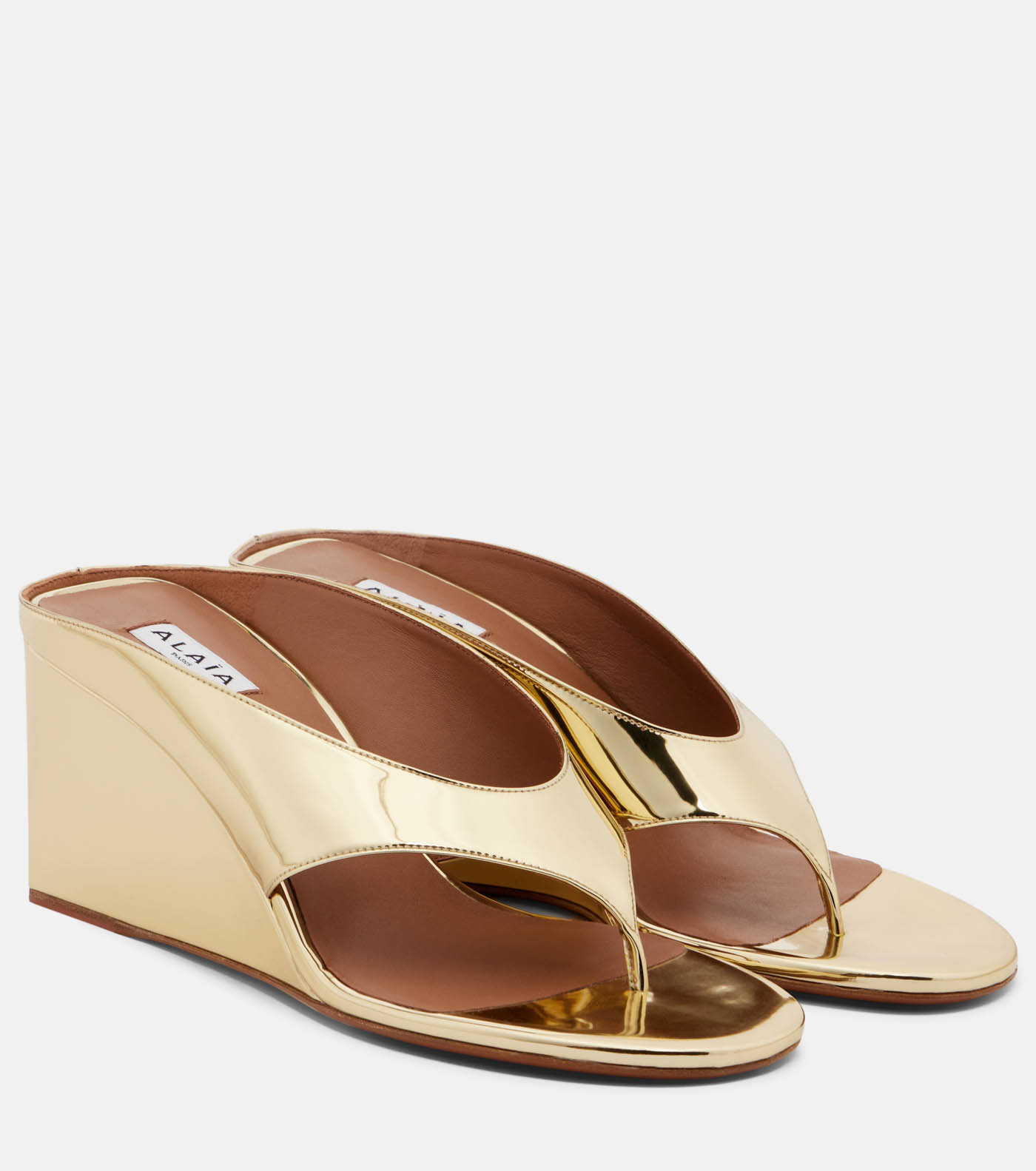 33 Alaia Cube Metallic Wedge Thong Sandals, $1,580, Mytheresa.com