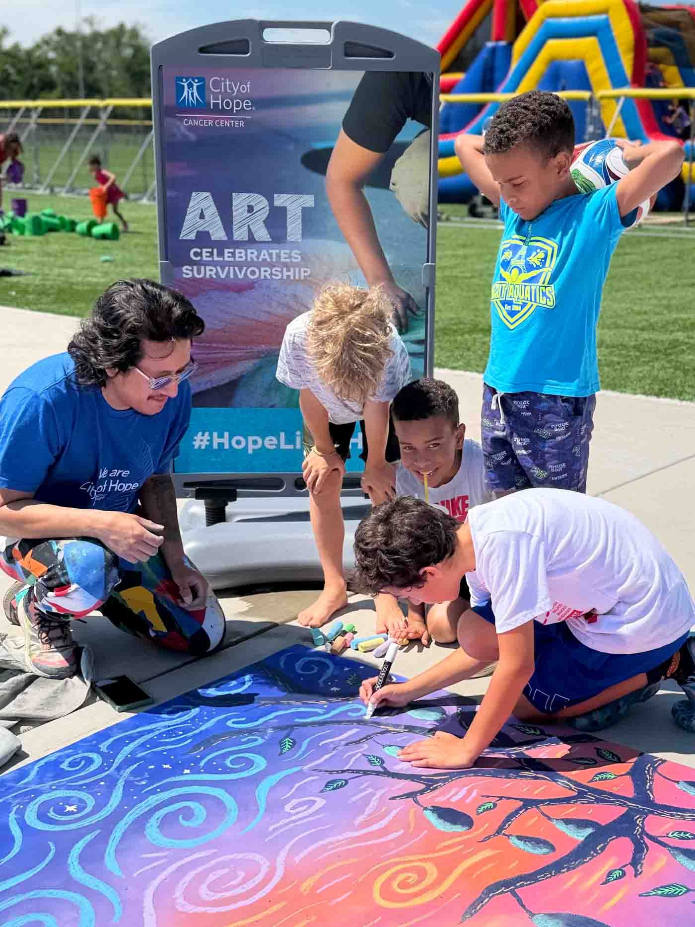 64 Cityofhope Luis And Kids Chalking 8x11 Photocreditcityofhope